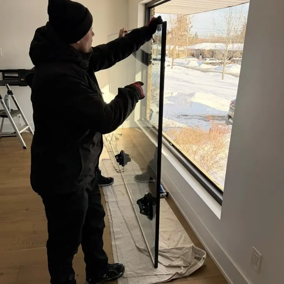 Technician preparing new residential glass for installation