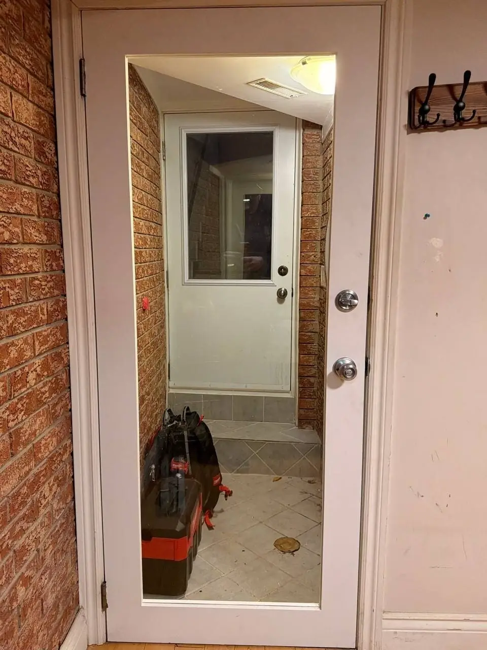 Replacement interior door with a full glass panel installed in an Etobicoke hallway