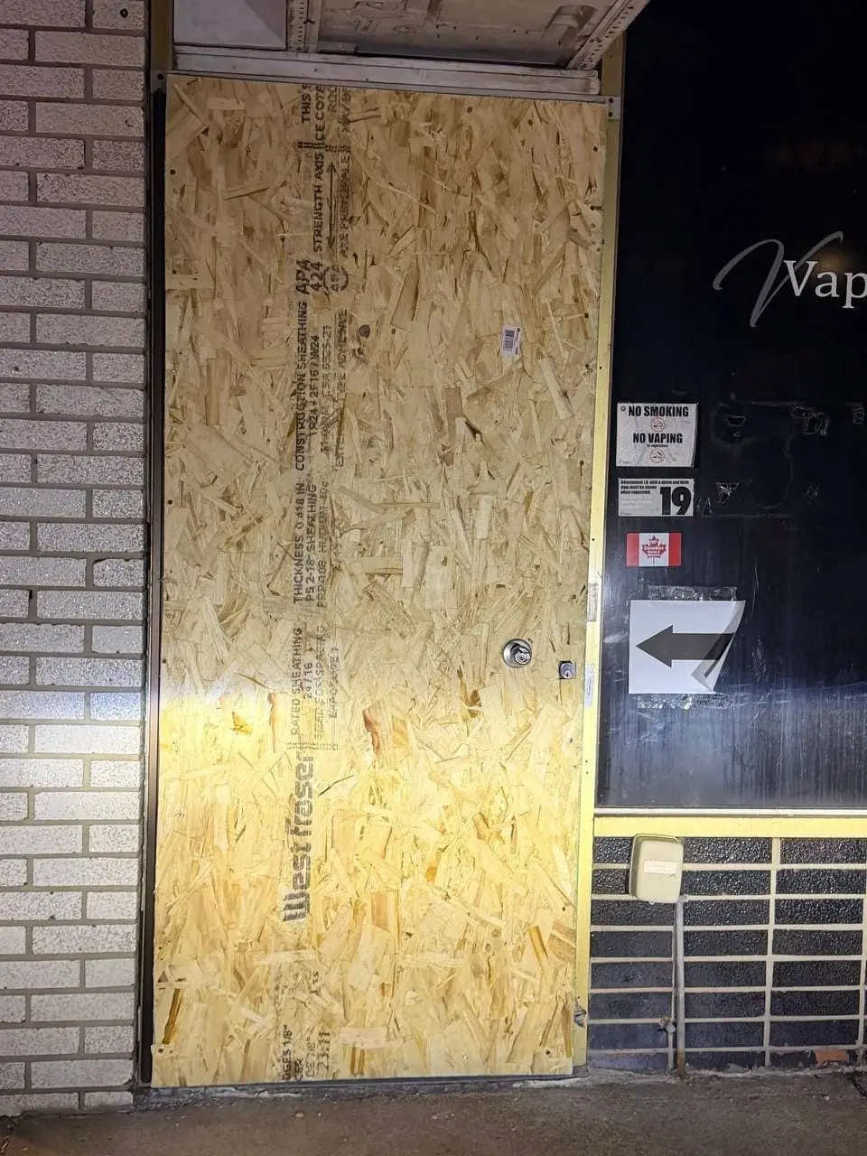 Mississauga shop entrance secured by the earlier emergency board-up before the permanent door replacement.