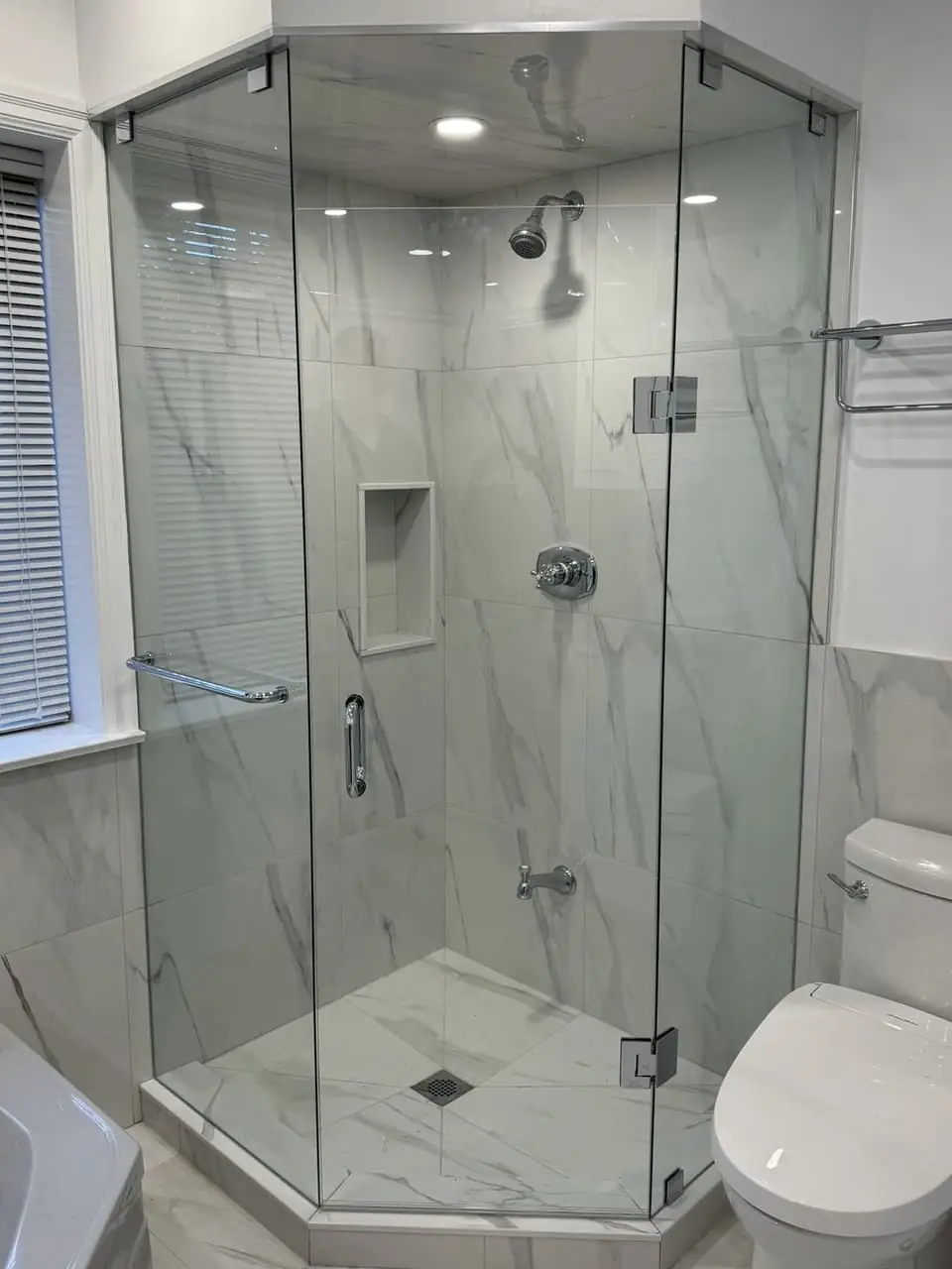 Completed custom neo-angle shower enclosure in Richmond Hill after glass alignment and perimeter silicone finishing.