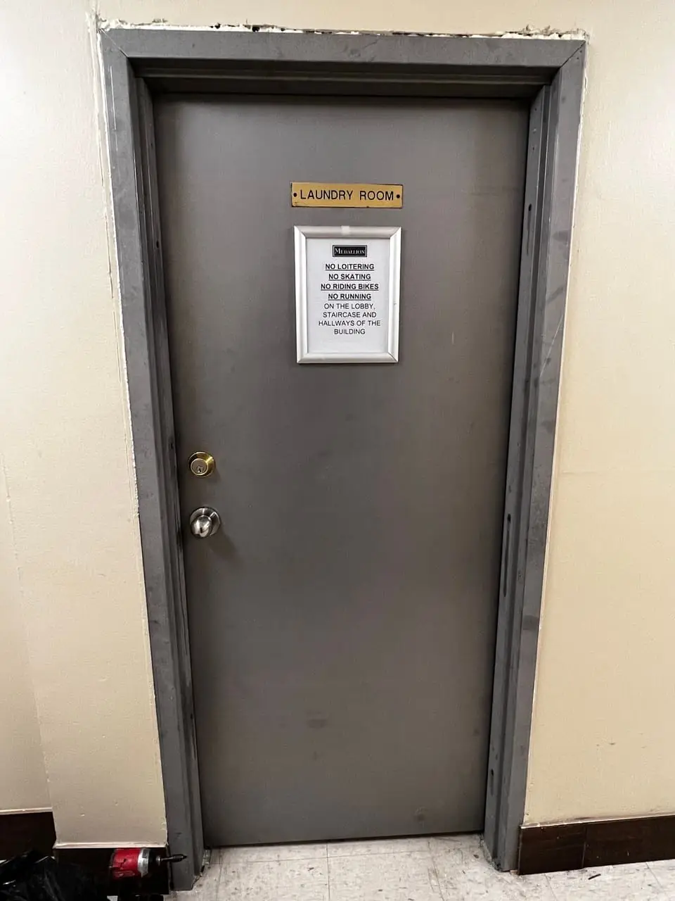 New fire-rated metal laundry room door installed in Whitby with improved fit and cleaner hallway appearance