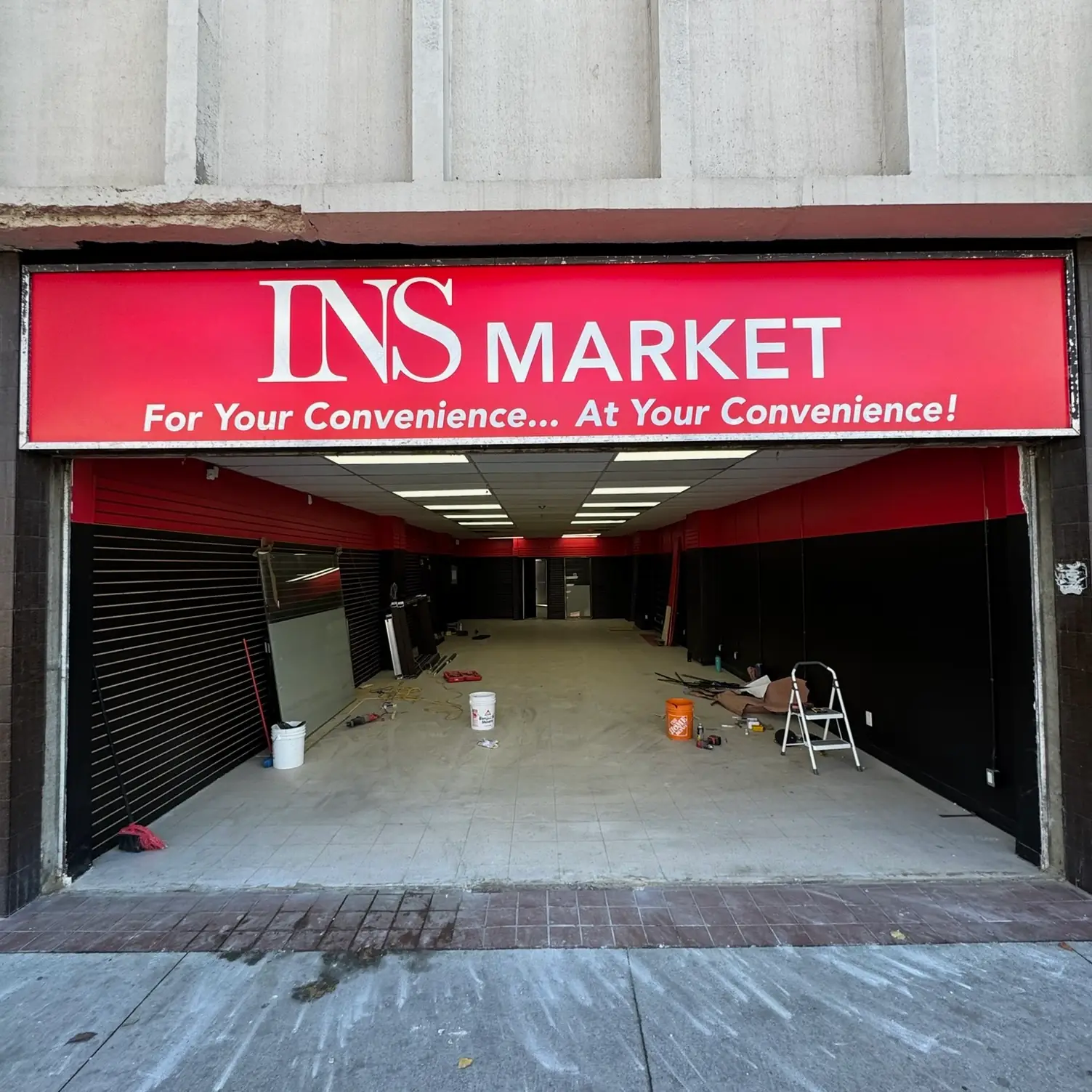 Existing retail storefront opening before aluminum storefront entrance replacement