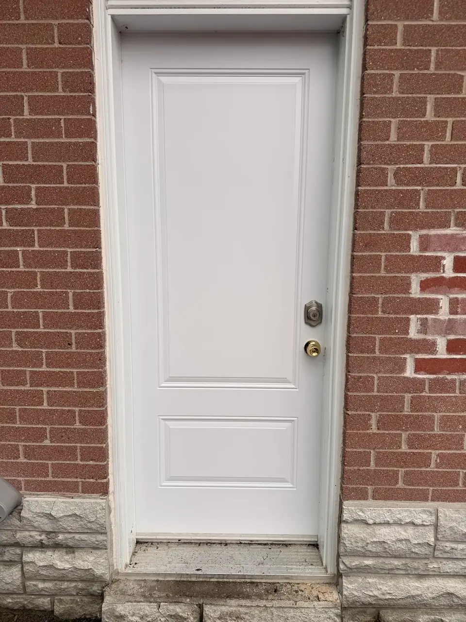 New white exterior entry door installed in Aurora after break-in damage