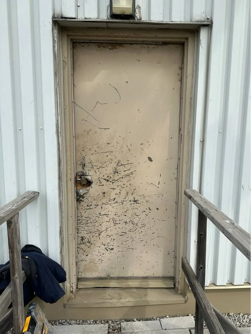 Failed exterior security door in Richmond Hill before commercial metal door replacement