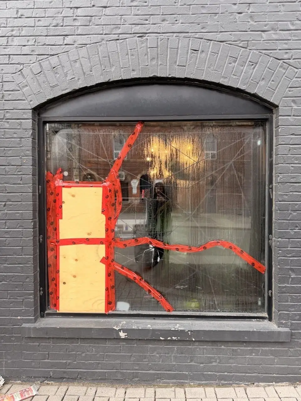 Parkdale tattoo-studio storefront opening with temporary protection before permanent glass replacement.