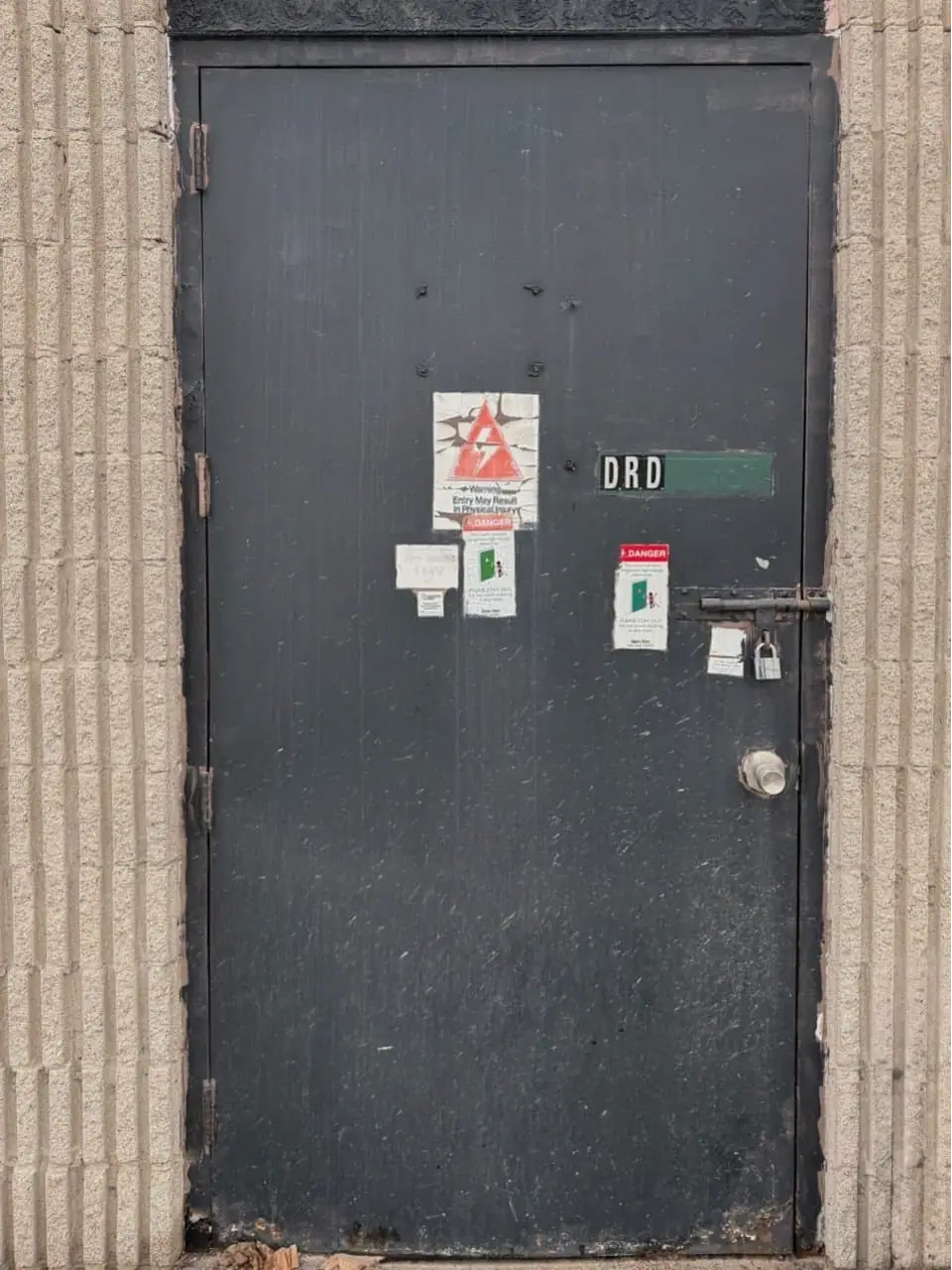 Old commercial steel entry door and unsealed perimeter in Richmond Hill before replacement