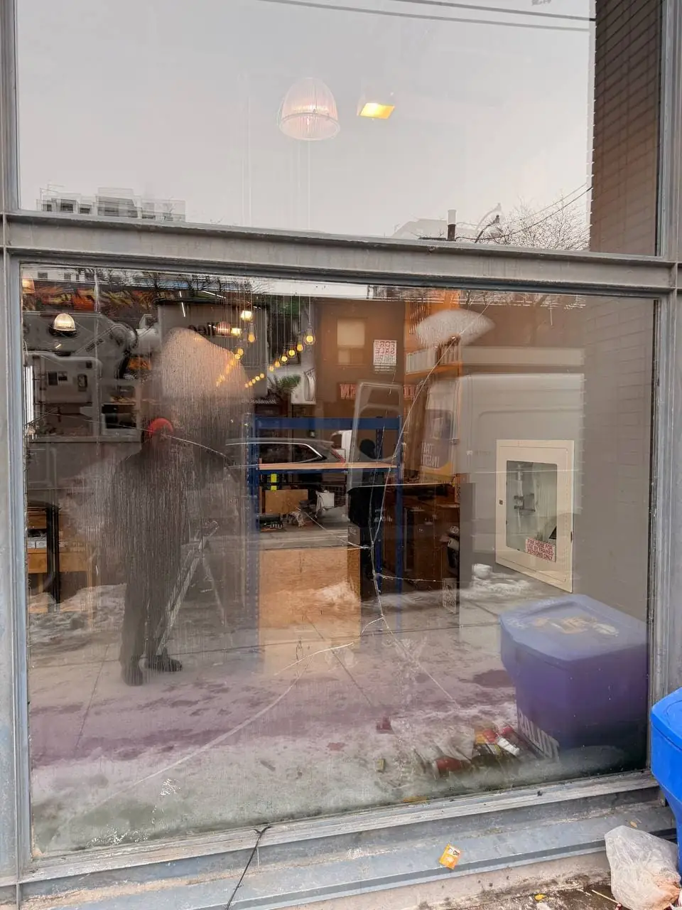 Cracked Queen West storefront glass unit in Toronto before replacement