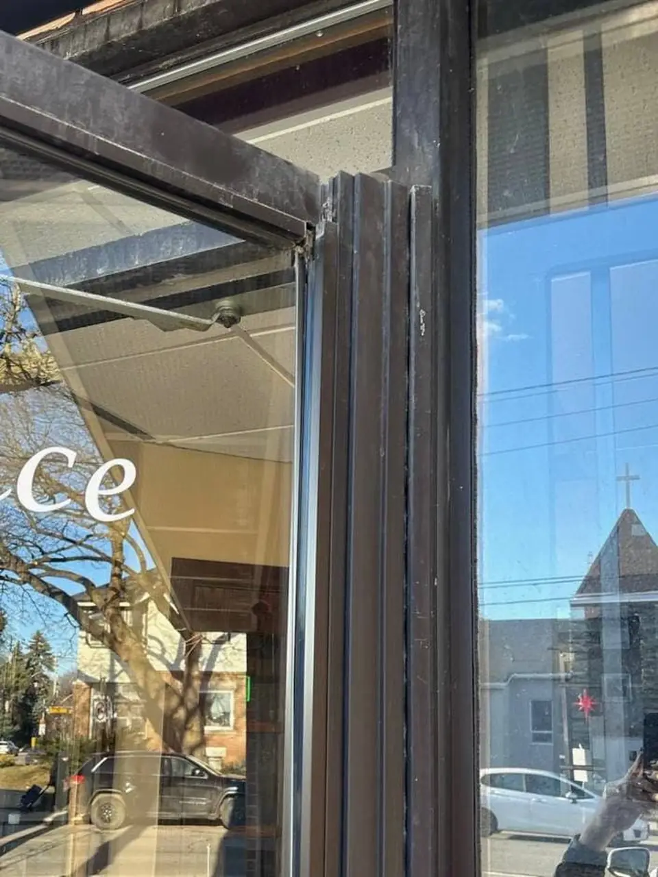 Damaged commercial door at Occasions Restaurant on Eastwood Rd before repair