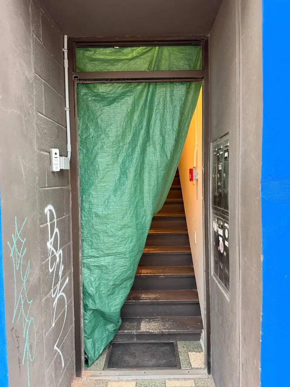 Tarped stairwell entrance in Pickering before the glass door replacement