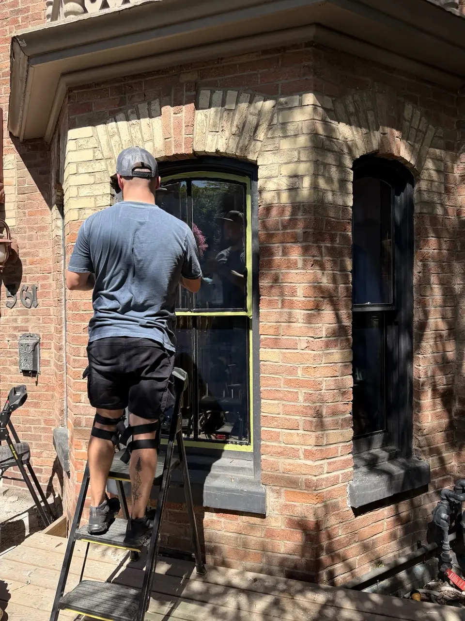 DoorWin technician restoring an old wooden window in Cabbagetown Toronto