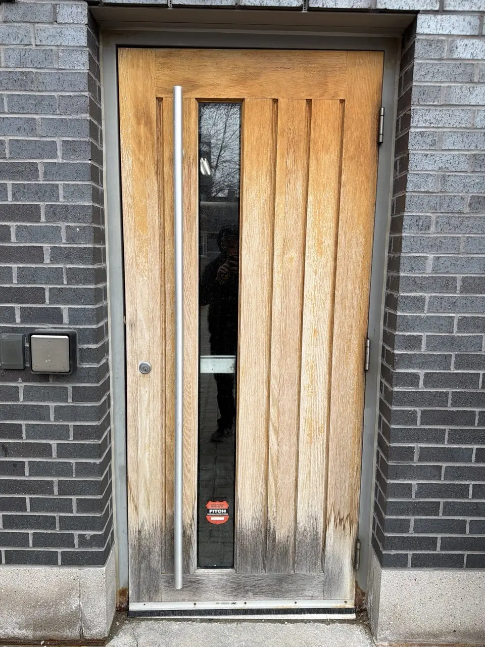 Worn exterior commercial door before replacement in Mississauga