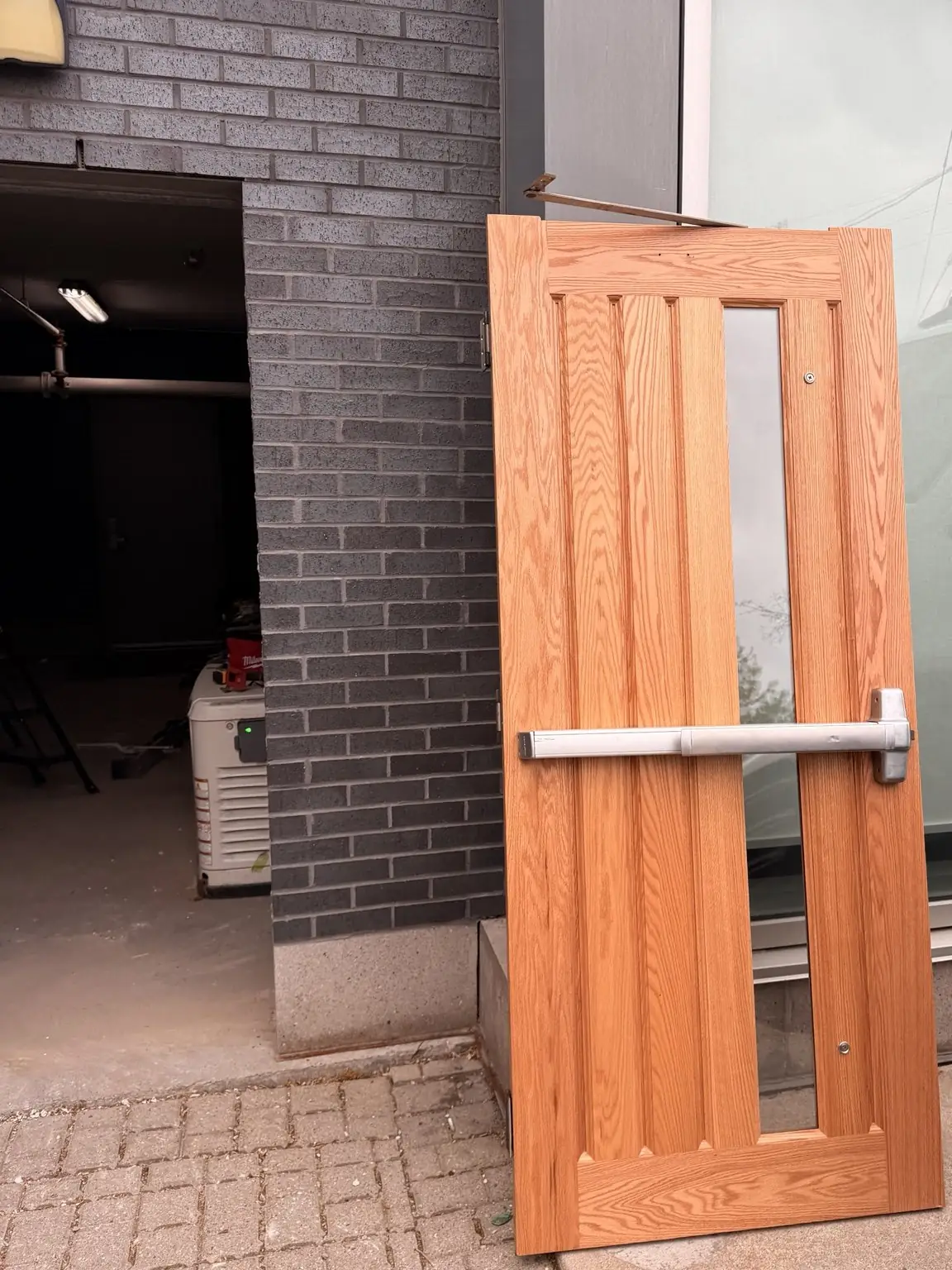 New wood grain commercial door prepared for installation
