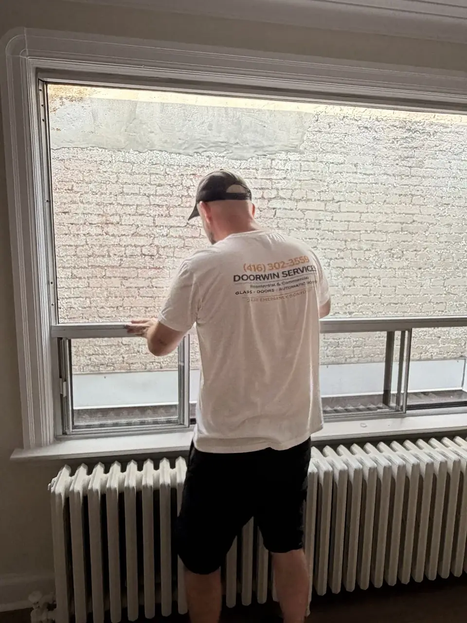 DoorWin Services technician installing a new sealed glass unit in Fairbank Toronto