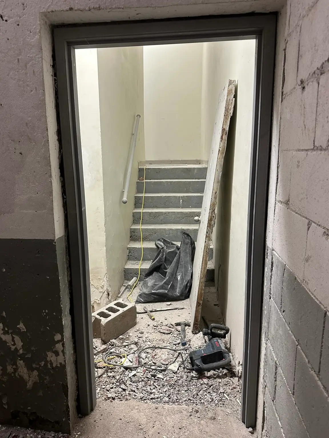 New hollow metal door frame installed and levelled in stairwell opening