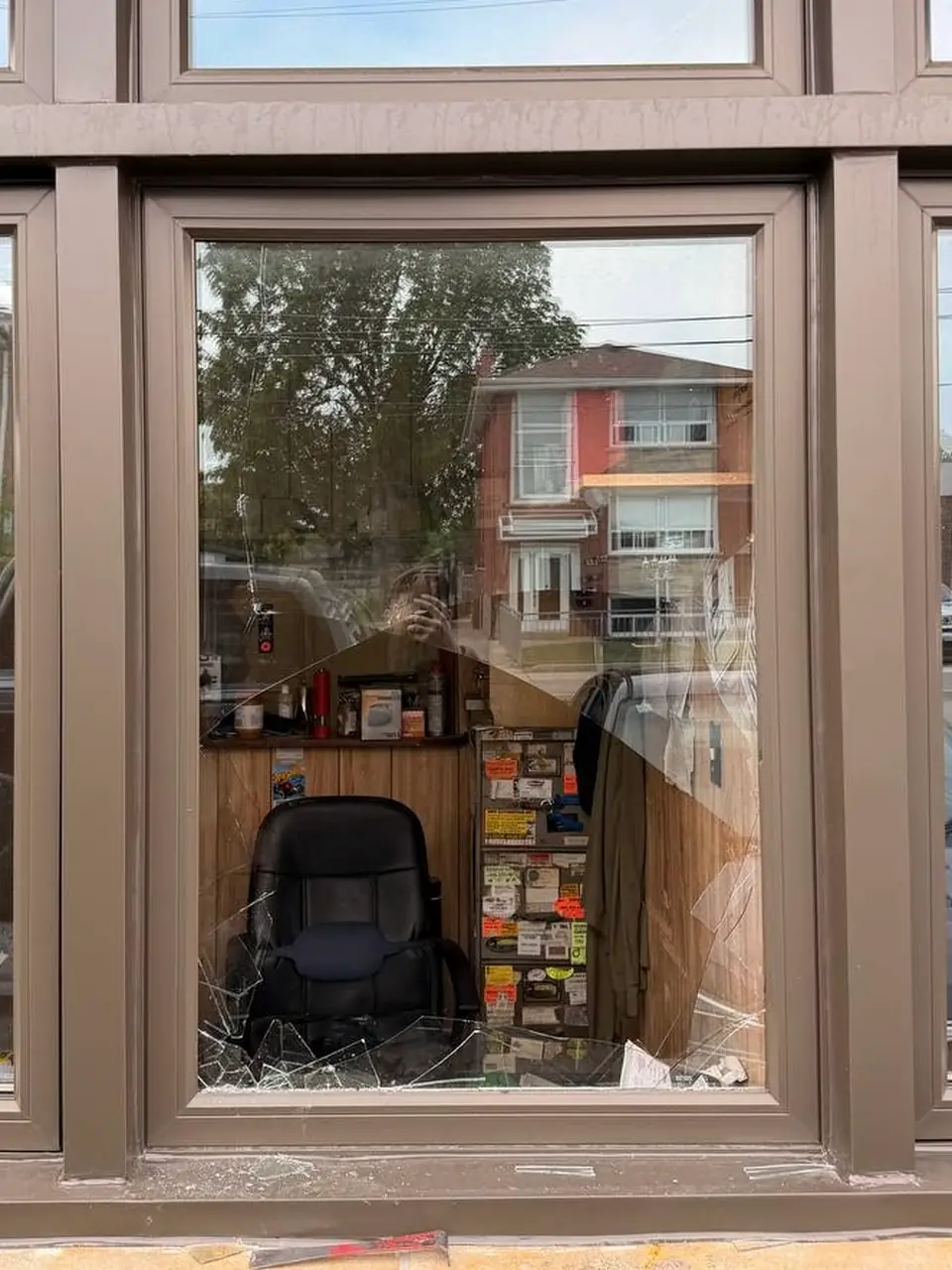 Broken commercial window at an auto repair shop in Mimico before emergency securing