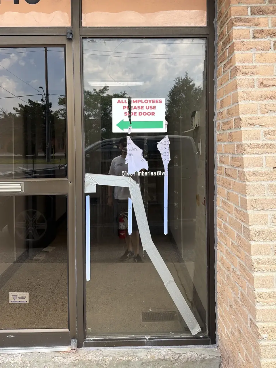 Damaged commercial storefront fixed glass panel before replacement in Mississauga