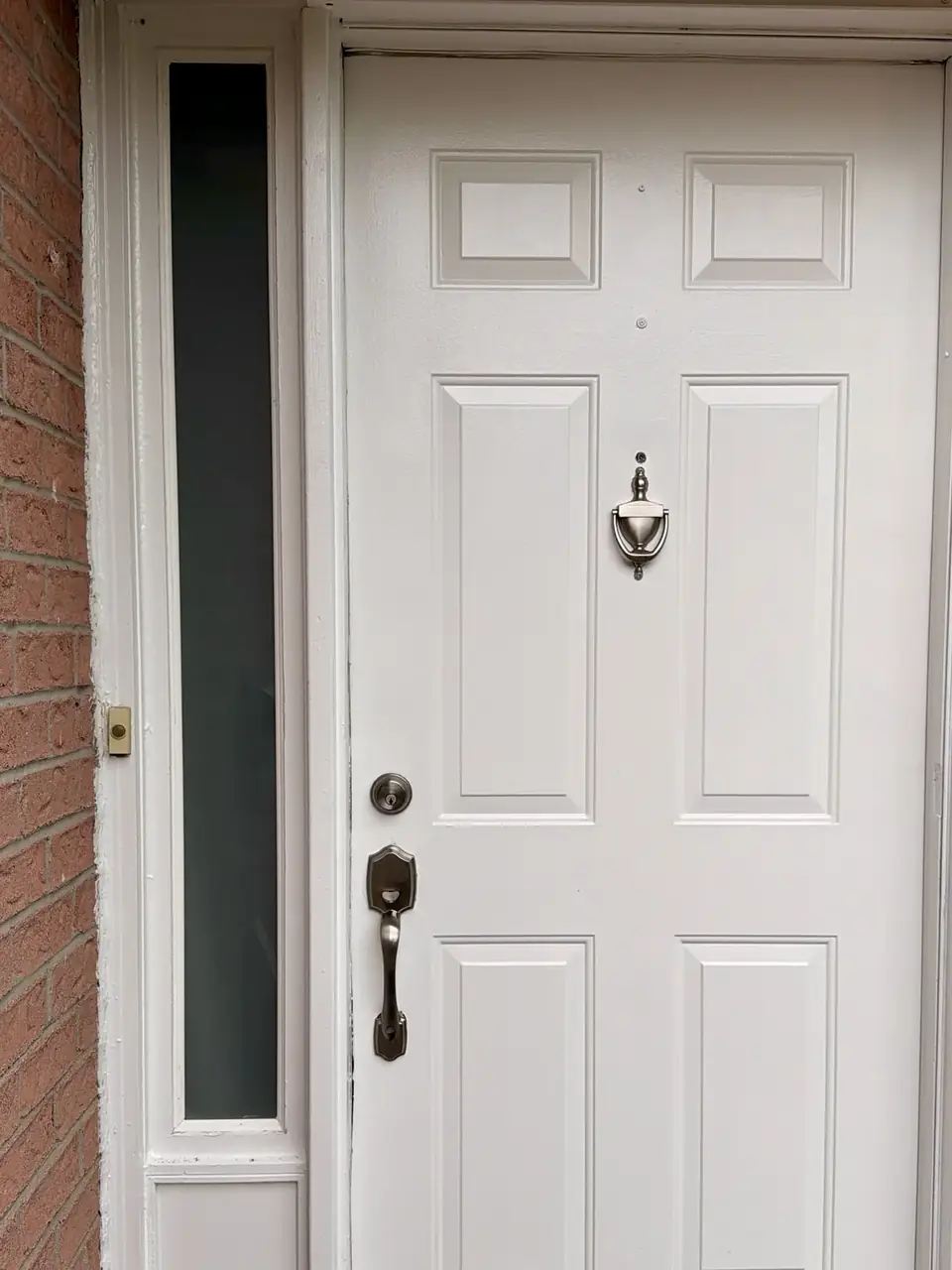 New entry door sidelight glass installed beside the existing front door in Mississauga