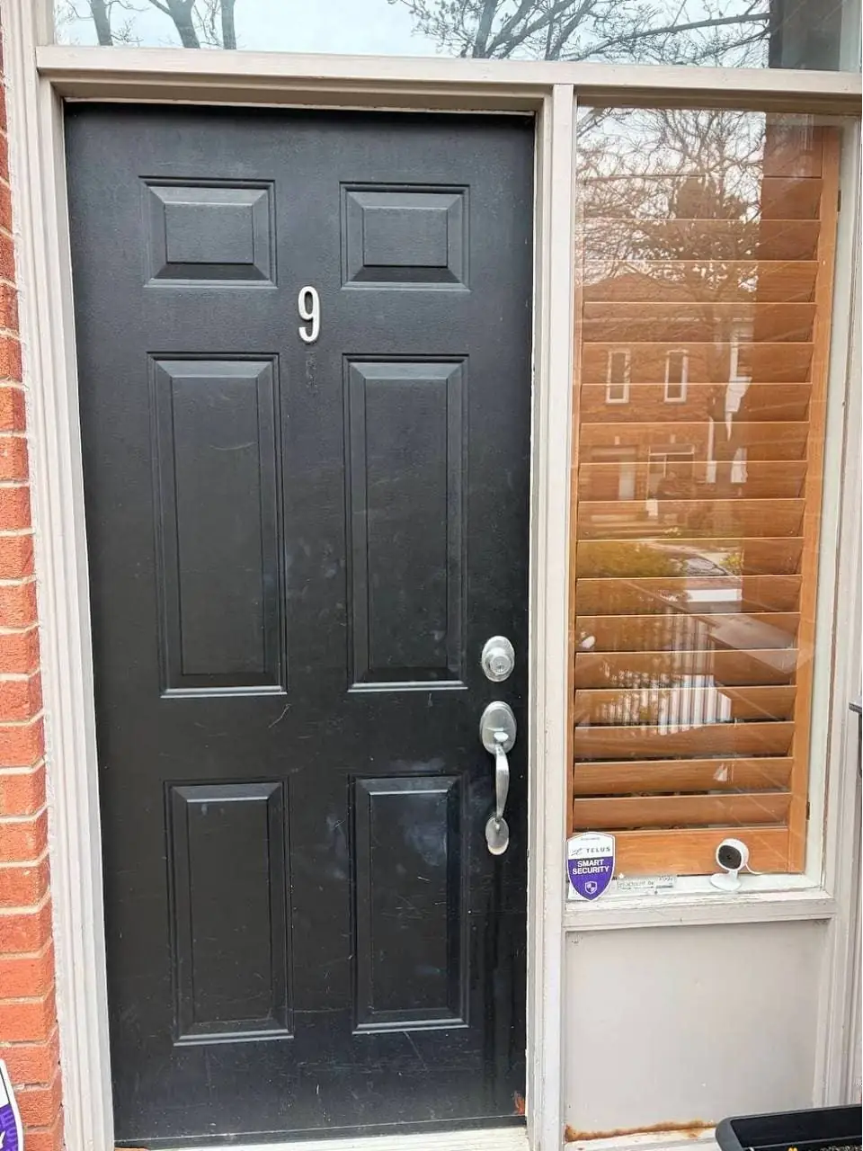 Old black front entry door in Newmarket before replacement