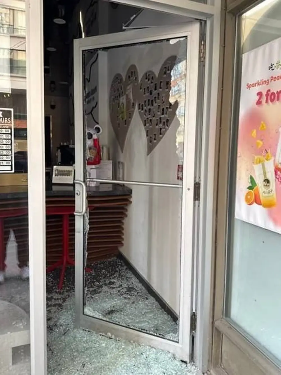 Broken glass in an Oshawa tea shop aluminum storefront door before replacement