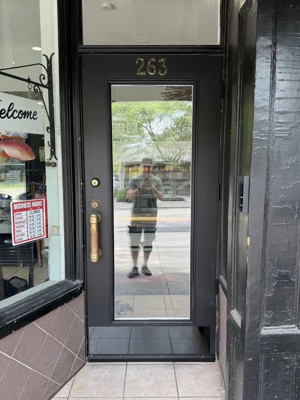 New black retail storefront entry door installed in Bloor West Village, Toronto