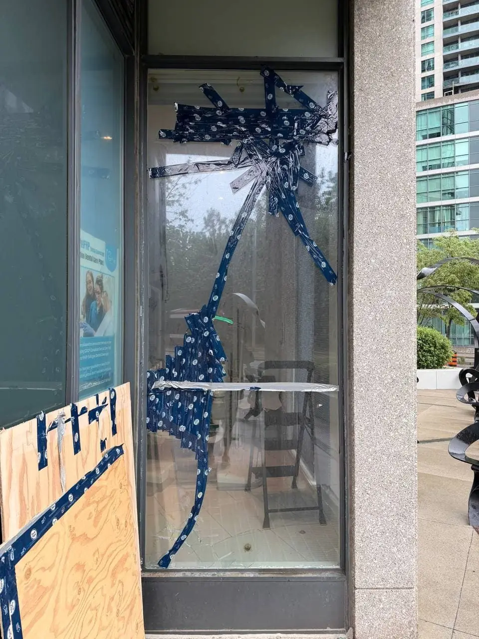 Broken storefront glass in Brampton before replacement