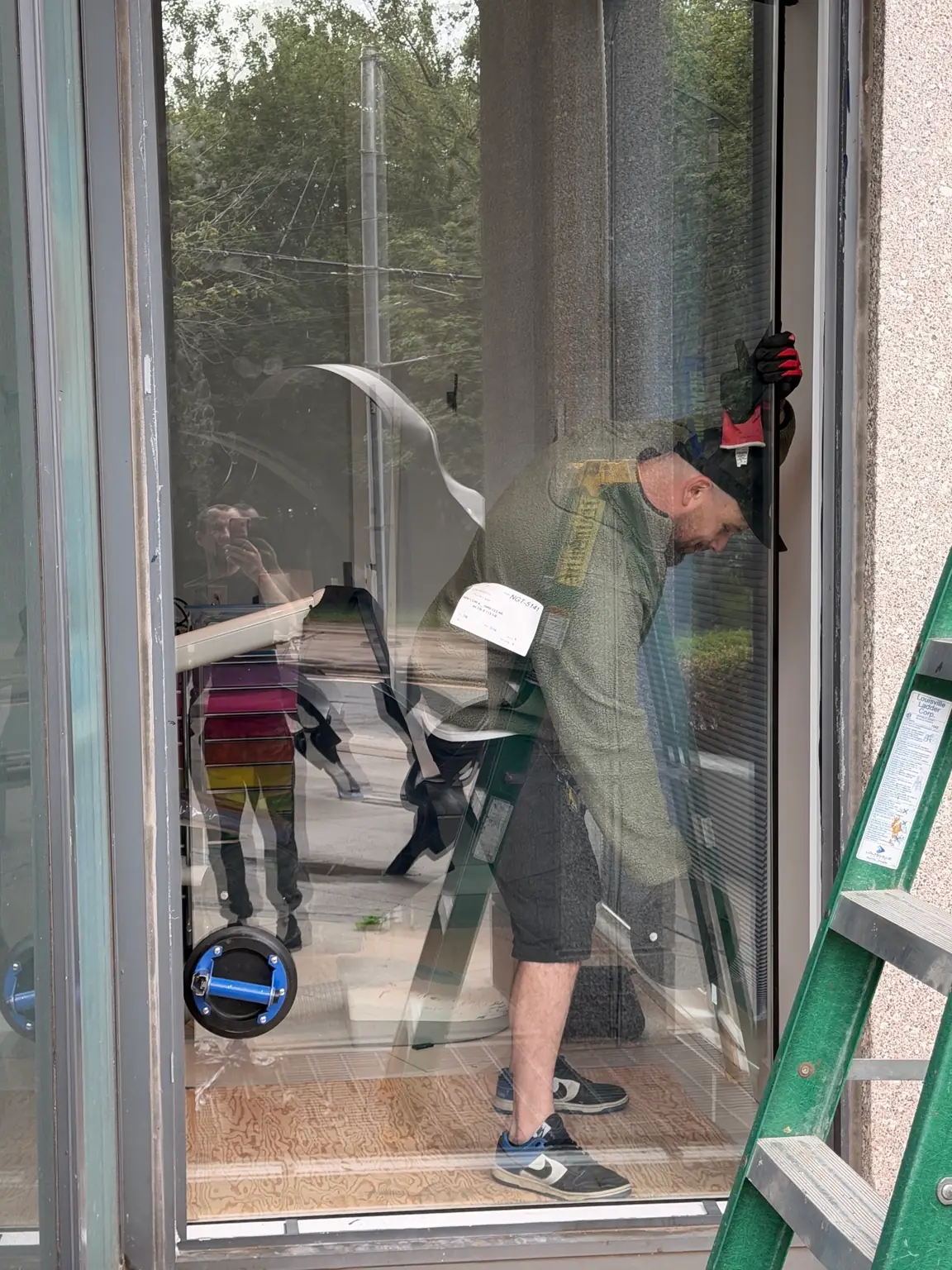 New storefront glass unit being installed into existing commercial frame
