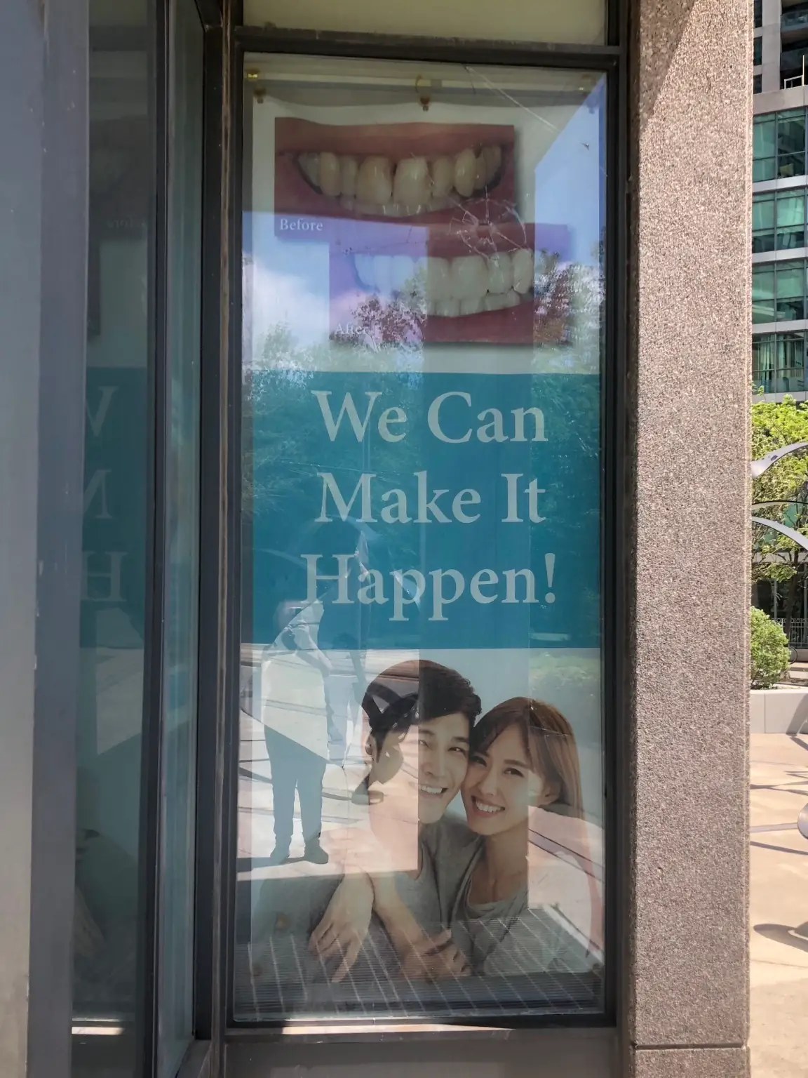 Advertising banner restored on new storefront glass after replacement