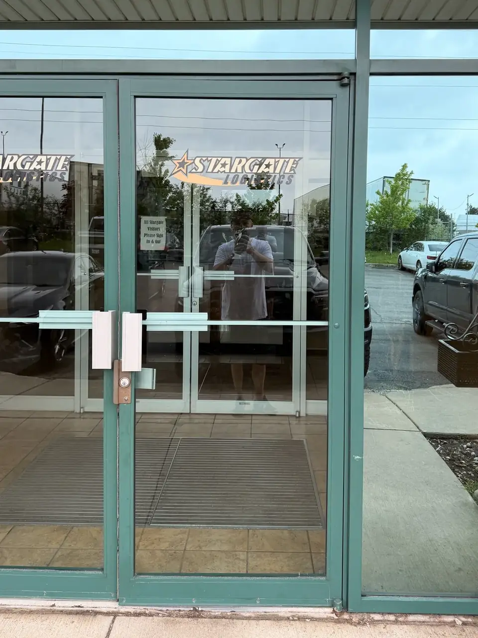 First of two aluminum commercial entrance doors in Mississauga before hinge repair