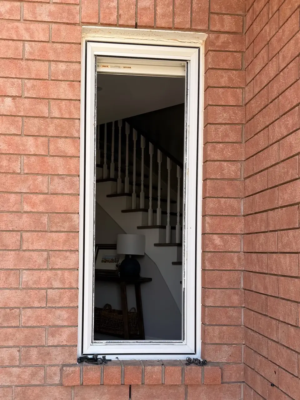 Bolton window opening after removal of the old insulated glass unit, with the original frame retained.